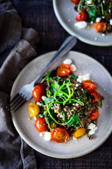 Quick Braised Lentils with Blistered Tomatoes and Kale-A simple vegetarian lentil recipe with blistered cherry tomatoes and wilted kale, seasoned with Middle Eastern spices & topped with feta. Healthy, tasty! | www.feastingathome.com #lentilrecipes #vegetarianlentils