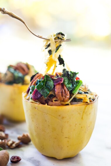 This recipe for Roasted Spaghetti Squash stuffed with kale, pecans, craisins and sage is easy to make. It's cozy and delicious for fall—vegan and gluten-free.