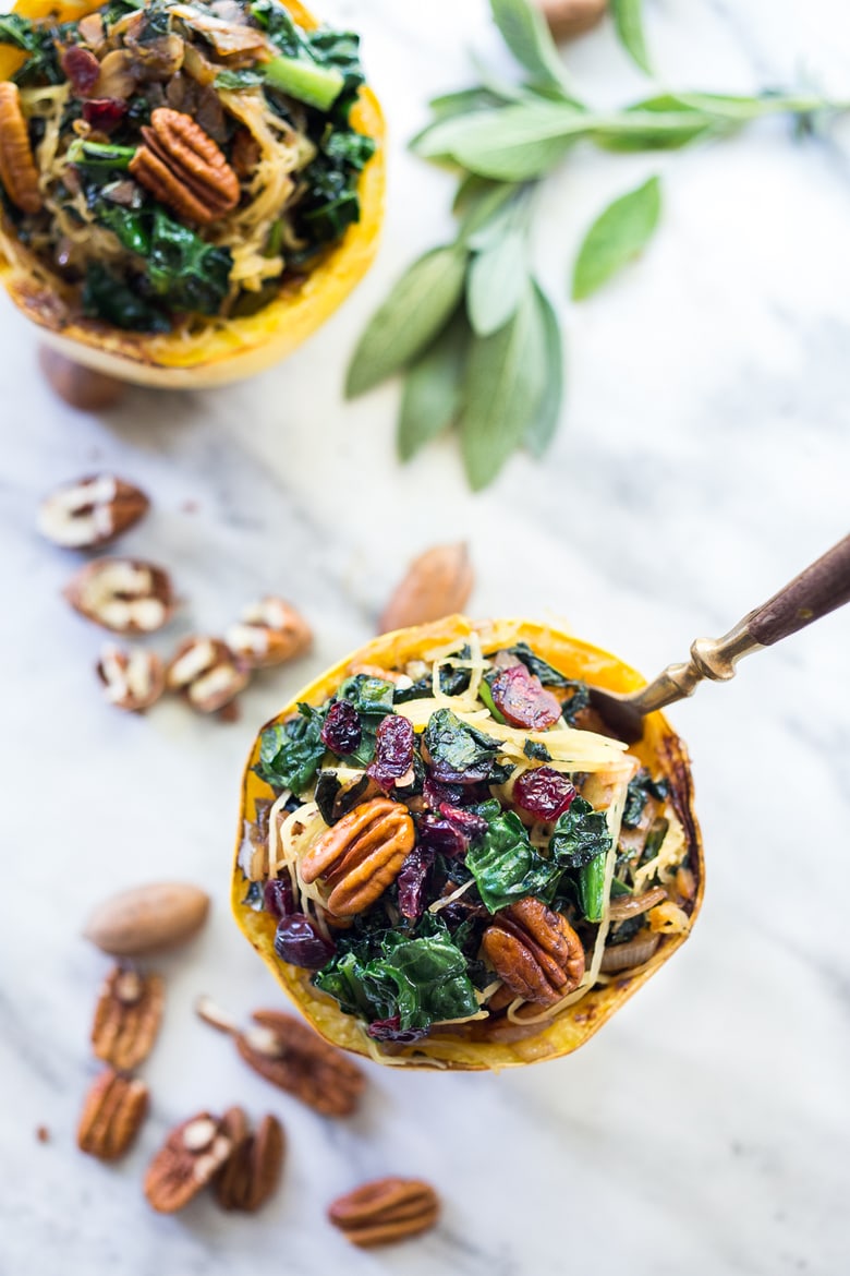 This recipe for Roasted Spaghetti Squash stuffed with kale, pecans, craisins and sage is easy to make. It's cozy and delicious for fall—vegan and gluten-free.