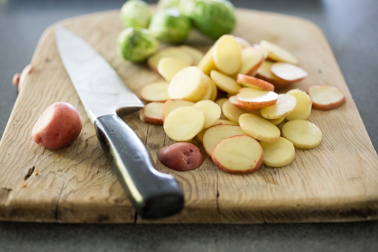 A simple healthy recipe for Roasted Mustard Seed White Fish with Potato-Brussel Sprout Hash, a quick and easysheet-pan dinner that is full of flavor. | www.feastingathome.com #sheetpan #onepan #brusselsprouts #mustard #whitefish #halibut #cod 