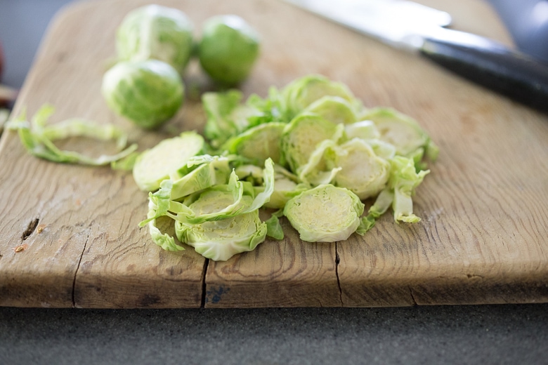 A simple healthy recipe for Roasted Mustard Seed White Fish with Potato-Brussel Sprout Hash, a quick and easysheet-pan dinner that is full of flavor. | www.feastingathome.com #sheetpan #onepan #brusselsprouts #mustard #whitefish #halibut #cod 