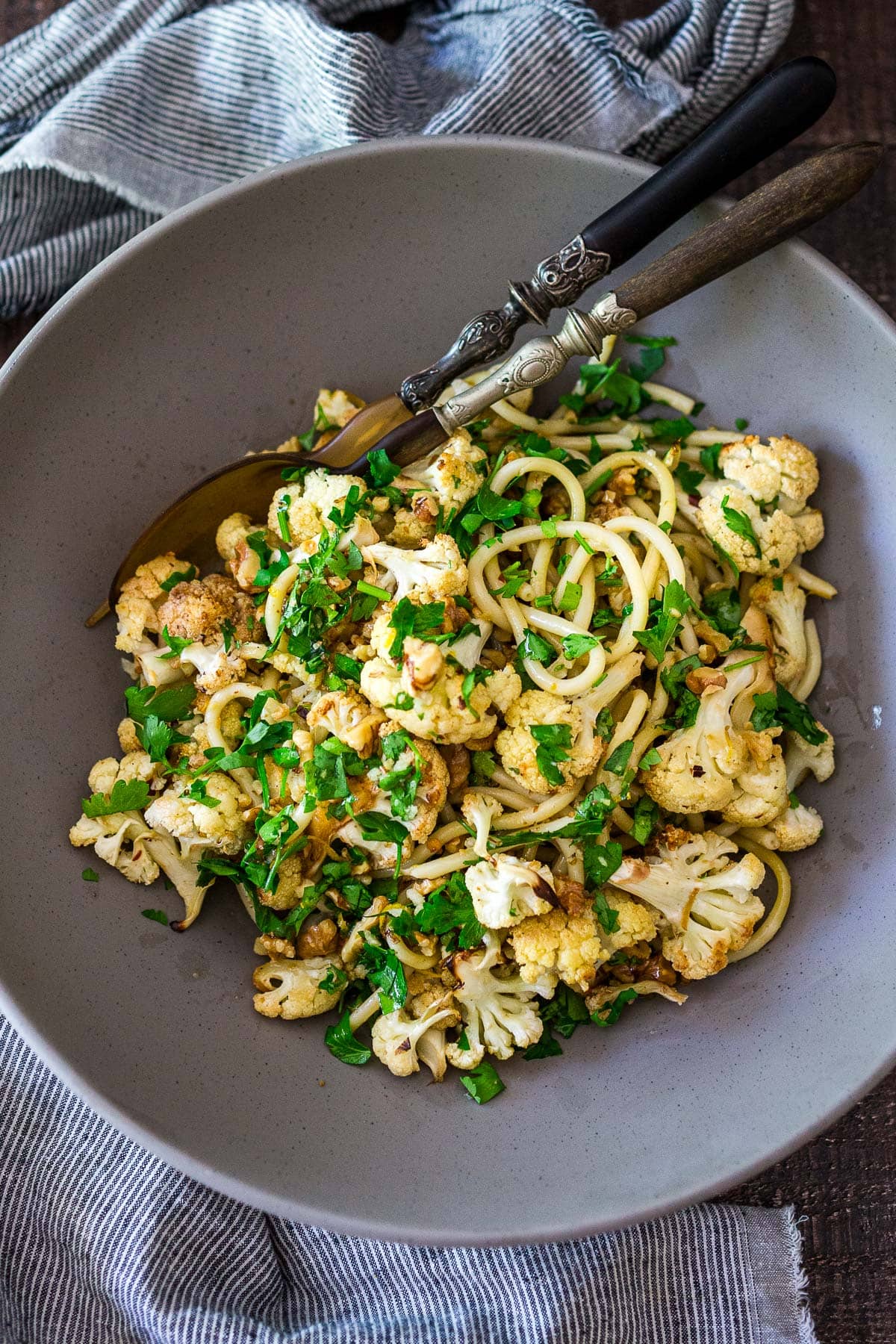 This roasted Cauliflower Pasta recipe is easy to make and completely delicious! It's made with toasted walnuts, garlic, fresh herbs and lemon zest. Video.