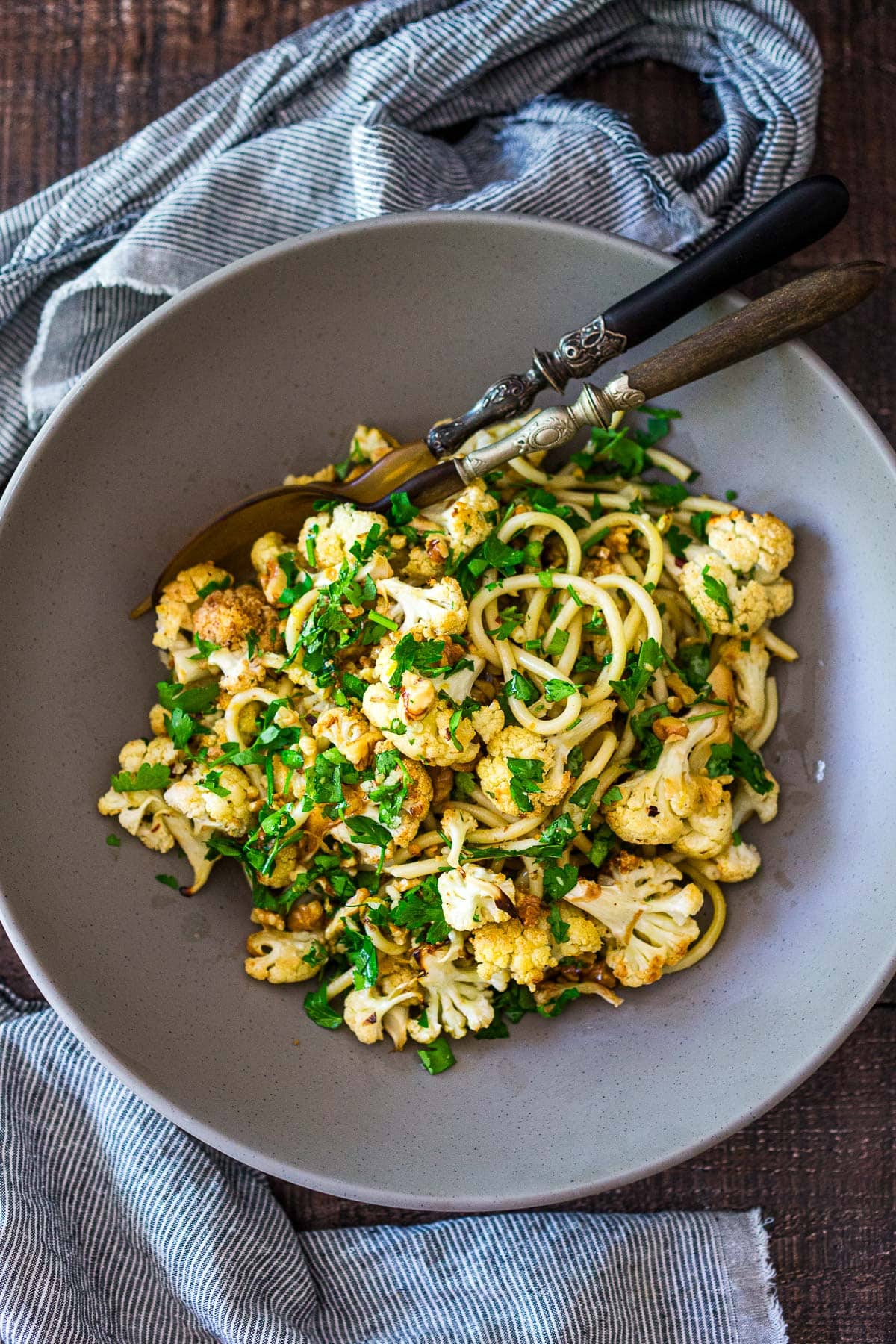 This roasted Cauliflower Pasta recipe is easy to make and completely delicious! It's made with toasted walnuts, garlic, fresh herbs and lemon zest. Video.