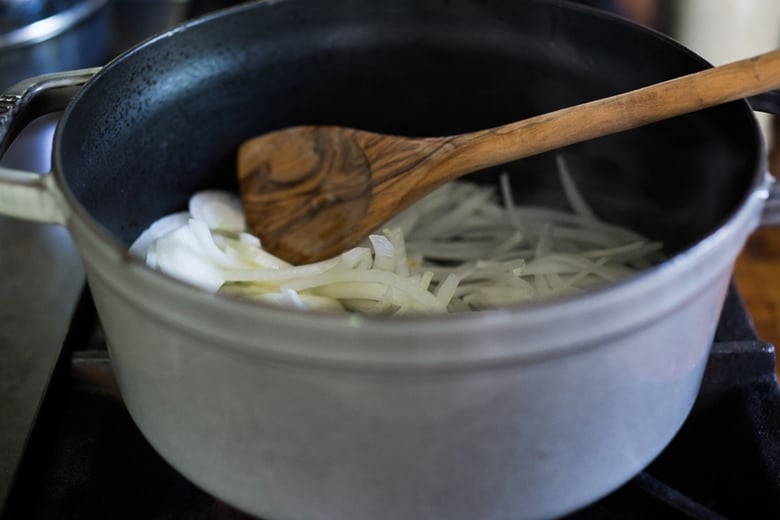 Sliced onions in a stock pot.