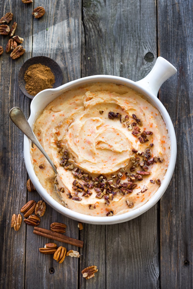 Creamy Mashed Carrots with potatoes, brown butter, toasted pecans and a whisper of nutmeg - a delicious addition to your holiday table. #mashedcarrots #carrotmash 