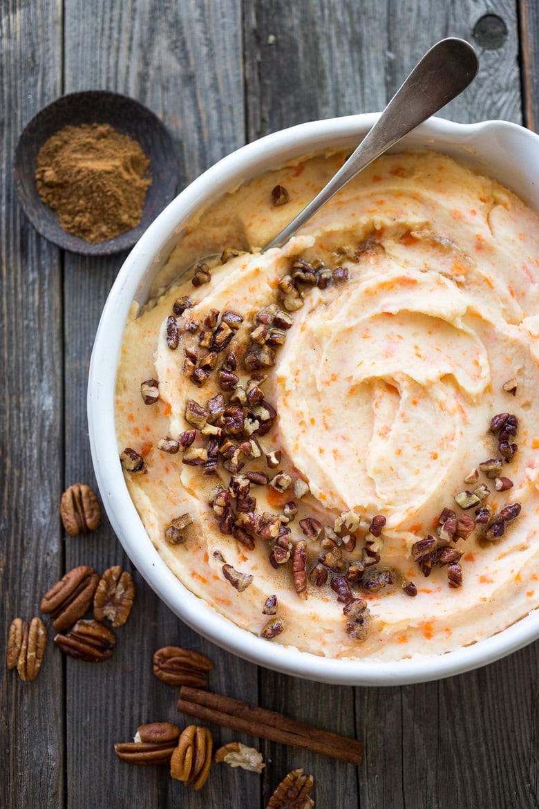 Creamy Mashed Carrots with potatoes, brown butter, toasted pecans and a whisper of nutmeg - a delicious addition to your holiday table. #mashedcarrots #carrotmash 