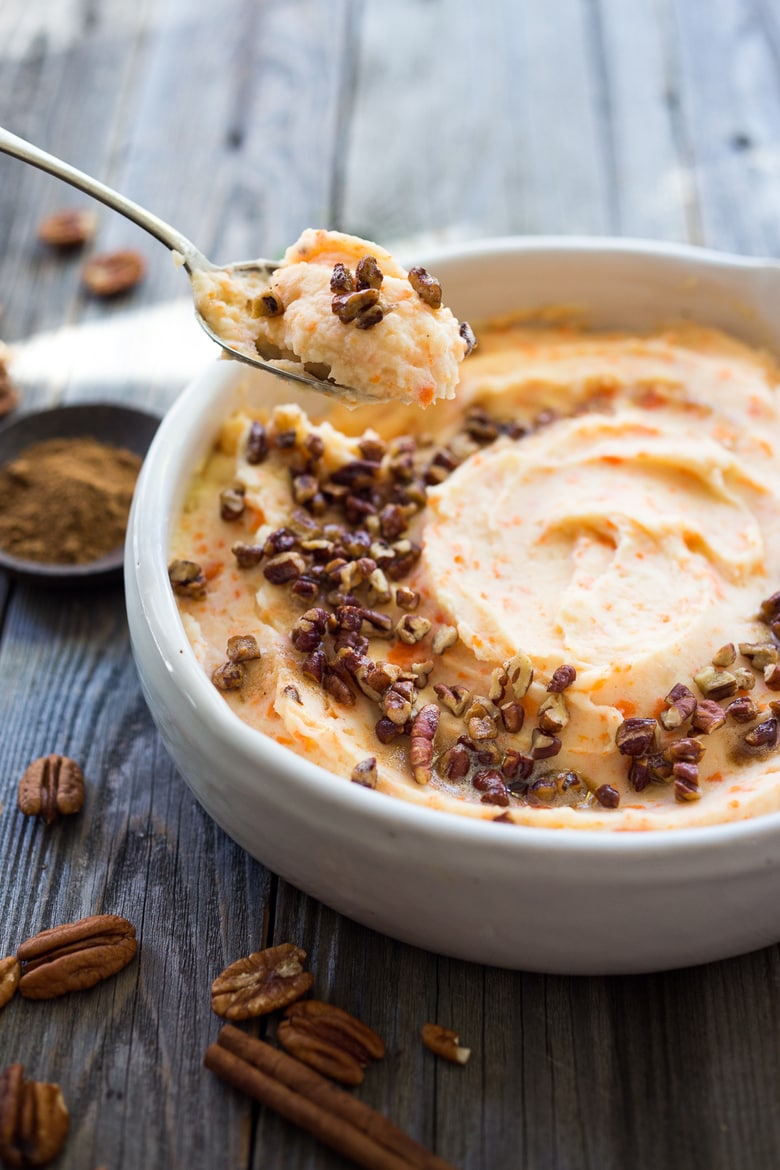 Creamy Mashed Carrots with potatoes, brown butter, toasted pecans and a whisper of nutmeg - a delicious addition to your holiday table. #mashedcarrots #carrotmash 