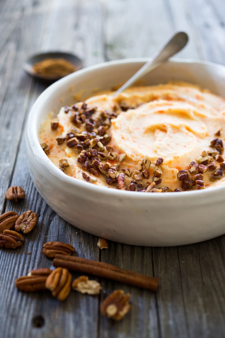 Creamy Mashed Carrots with potatoes, brown butter, toasted pecans and a whisper of nutmeg - a delicious addition to your holiday table. #mashedcarrots #carrotmash 