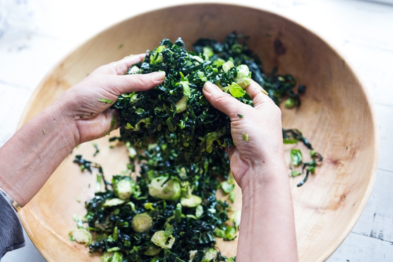 A hearty, healthy Roasted Fall Vegetable Salad with Maple Curry Vinaigrette on a bed of shredded kale and brussel sprouts. Vegan and GF. | www.feastingathome.com