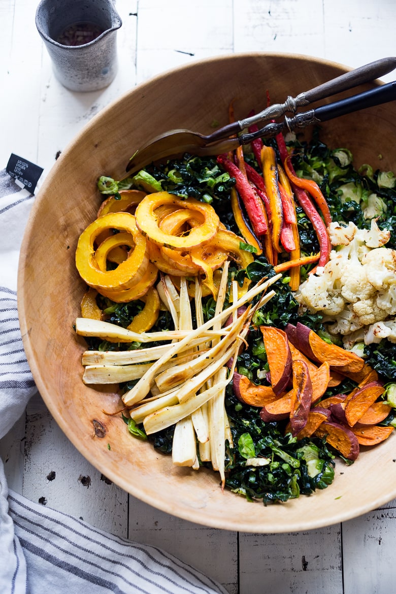 This Roasted Vegetable Salad with Maple Curry Dressing is full of fantastic flavor and perfect for fall gatherings or the holiday table. Served over a bed of shredded kale it is hearty and nutritious. Vegan and GF. 