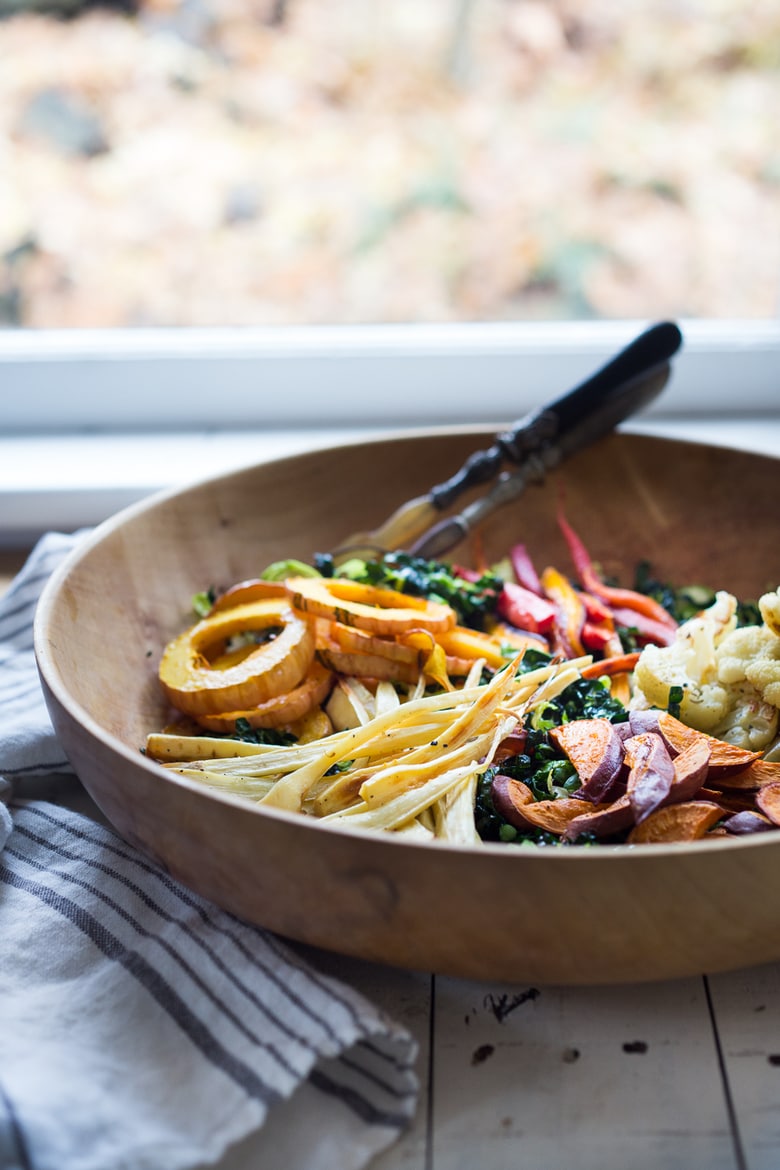 This Roasted Vegetable Salad with Maple Curry Dressing is full of fantastic flavor and perfect for fall gatherings or the holiday table. Served over a bed of shredded kale it is hearty and nutritious. Vegan and GF. 