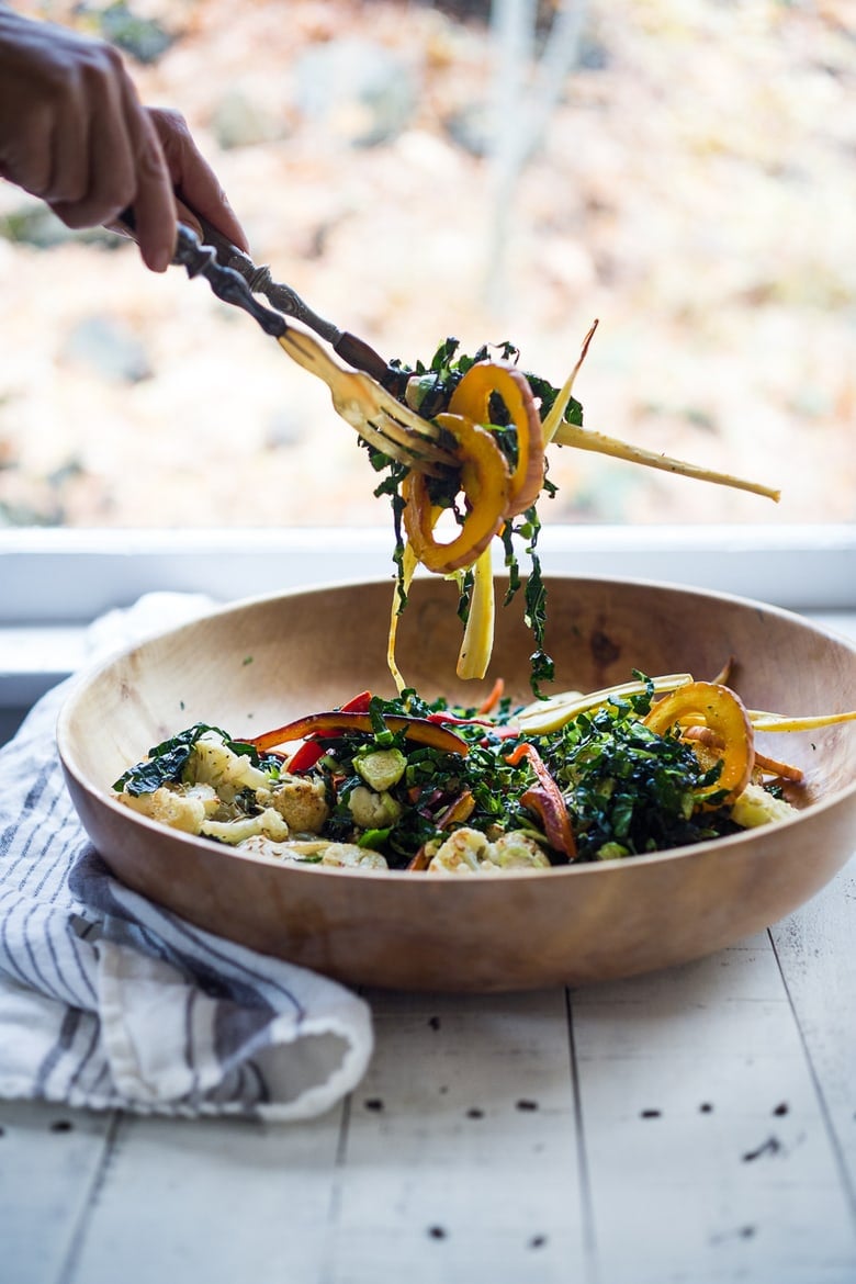 This Roasted Vegetable Salad with Maple Curry Dressing is full of fantastic flavor and perfect for fall gatherings or the holiday table. Served over a bed of shredded kale it is hearty and nutritious. Vegan and GF. 