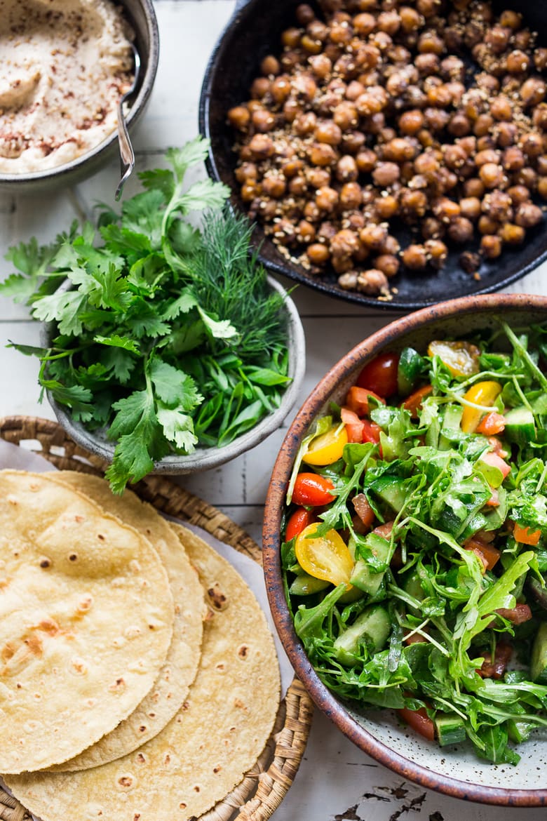 Middle Eastern Salad Tacos with spiced chickpeas, hummus and a mound of lemony salad, topped with fresh herbs and scallions. Vegan & sooooo Delicious! | www.feastingathome.com