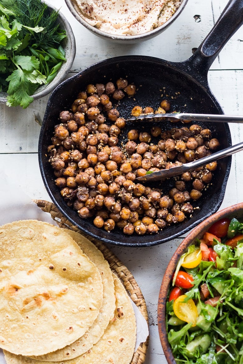 Middle Eastern Salad Tacos with spiced chickpeas, hummus and a mound of lemony salad, topped with fresh herbs and scallions. Vegan & sooooo Delicious! | www.feastingathome.com