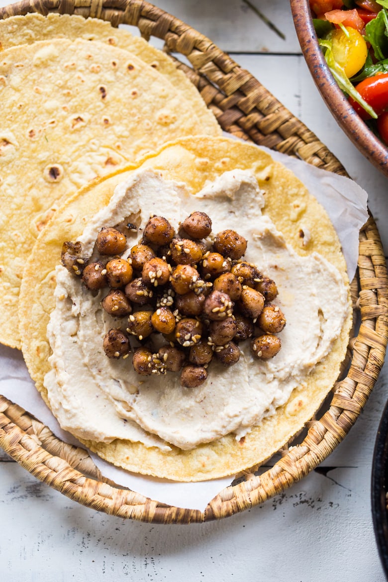 Middle Eastern Salad Tacos with spiced chickpeas, hummus and a mound of lemony salad, topped with fresh herbs and scallions. Vegan & sooooo Delicious! | www.feastingathome.com