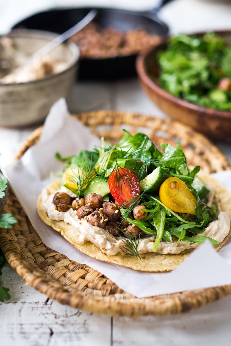 Middle Eastern Salad Tacos with spiced chickpeas, hummus and a mound of lemony salad, topped with fresh herbs and scallions. Vegan & sooooo Delicious! | www.feastingathome.com