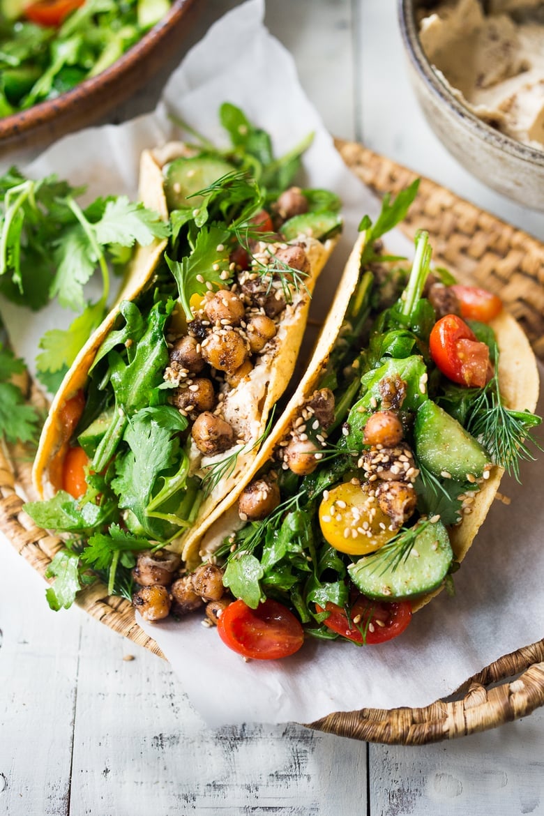 Middle Eastern Salad Tacos with spiced chickpeas, hummus and a mound of lemony salad, topped with fresh herbs and scallions. Vegan & sooooo Delicious! | www.feastingathome.com