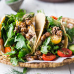 Middle Eastern Salad Tacos with spiced chickpeas, hummus and lemony salad, topped with fresh herbs and scallions. Vegan, Delicious! | www.feastingathome.com