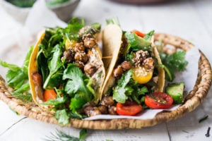 Middle Eastern Salad Tacos with spiced chickpeas, hummus and lemony salad, topped with fresh herbs and scallions. Vegan, Delicious! | www.feastingathome.com
