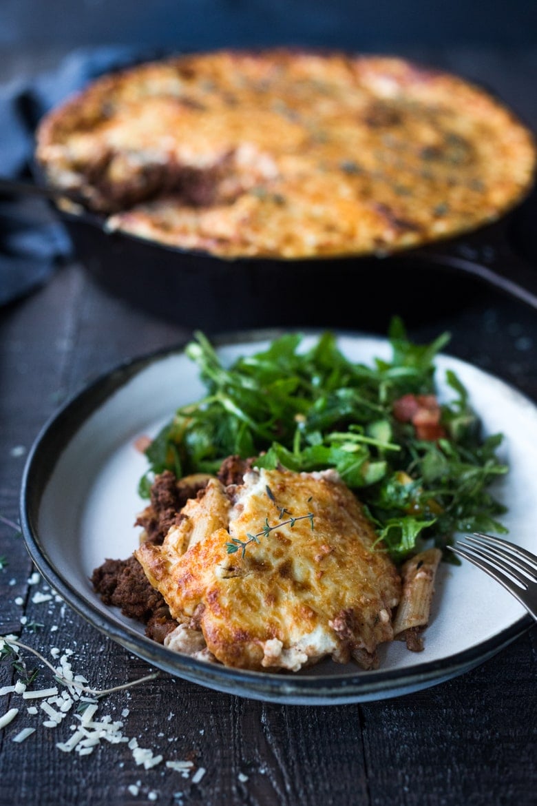 plate with serving of pastitsio and leafy green salad.