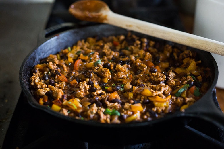 Simple Delicious Tamale Pie with your choice of ground turkey, beef or veggie meat with seasonal veggies, topped with a delicious cornbread crust. | www.feastingathome.com 