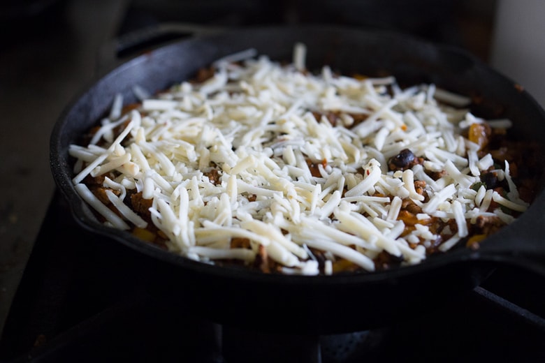 Simple Delicious Tamale Pie with your choice of ground turkey, beef or veggie meat with seasonal veggies, topped with a delicious cornbread crust. | www.feastingathome.com 