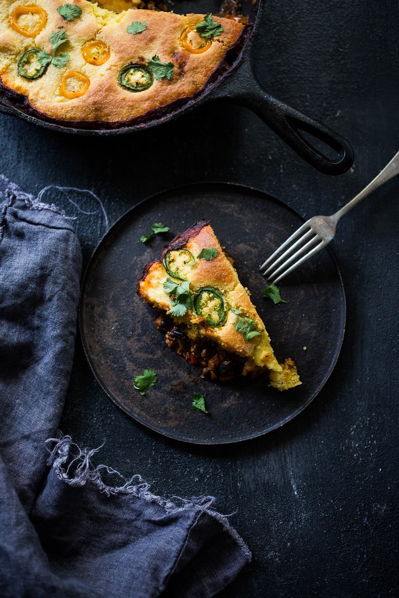 Simple Delicious Tamale Pie with your choice of ground turkey, beef or veggie meat with seasonal veggies, topped with a delicious cornbread crust. | www.feastingathome.com 