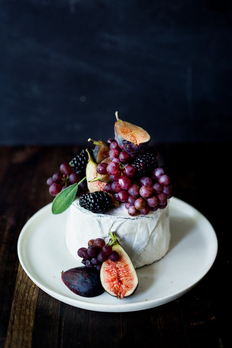 Simple, beautiful Brie Cake topped with fresh berries, figs and grapes, drizzled with honey and served with seeded crackers -  an easy, festive appetizer or dessert, perfect for celebrations and gatherings.  | www.feastingathome.com