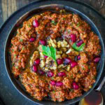 Discover a vibrant, authentic Muhammara dip — sweet, smoky roasted red peppers blended with toasted walnuts, pomegranate molasses, and Middle Eastern spices. Perfect as a mezze dip, sandwich spread, or festive party appetizer. Vegan.