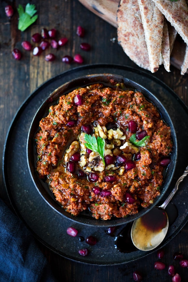 25 Festive Party appetizers like this simple, flavorful Middle Eastern-style, Roasted Red Pepper - Walnut Dip called Muhammara, with garlic, parsley and pomegranate molasses ( recipe below) , that can be made ahead in food processor. Serve with toasted pita or crackers.