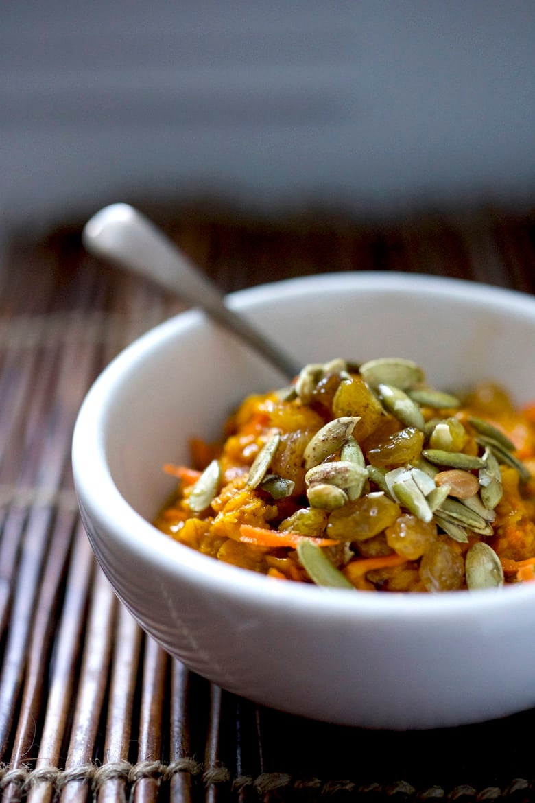 A warming recipe for Carrot Cake Oatmeal- a delicious vegan breakfast infused with warming spices,  healthy and comforting, perfect for cozy mornings.  