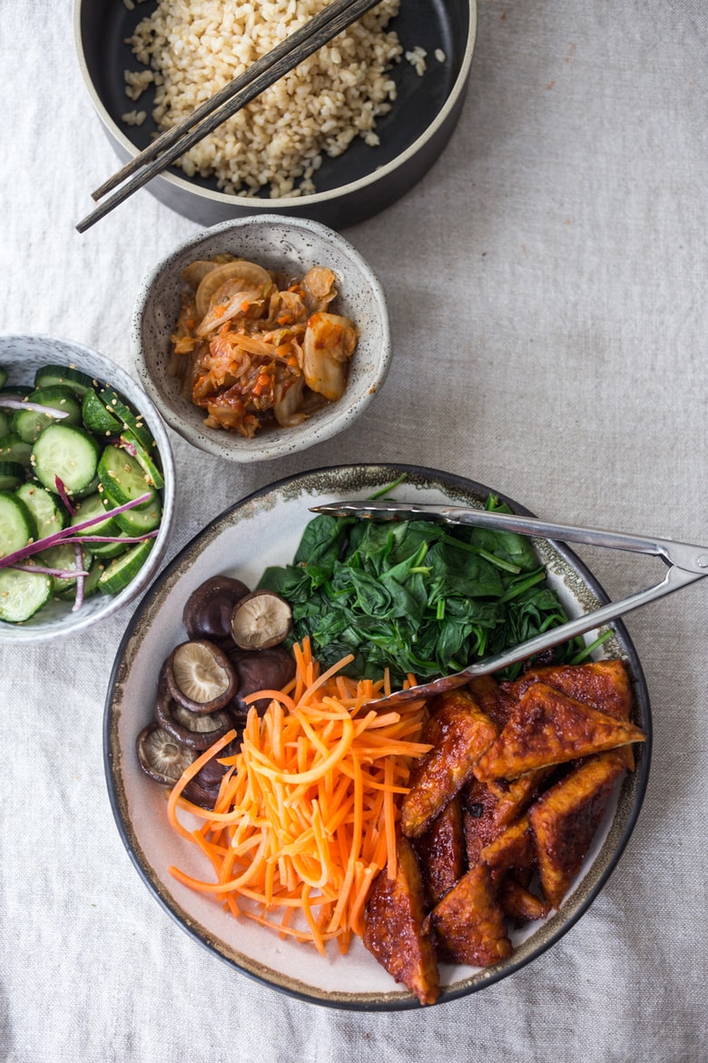This Bibimbap recipe (aka Seoul Bowl) is made with gochujang-baked Tempeh, steamed veggies, kimchi and quick pickled cucumbers- a healthy vegan version of Bibimbap! 