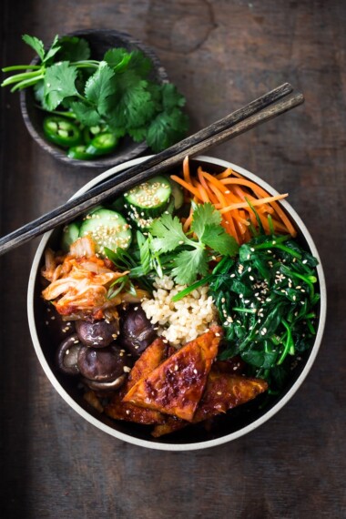 Korean-Style Seoul Bowl ( Bibimbap!)  with Gochujang baked Tempeh, steamed veggies, kimchi and pickled cucumber- a healthy vegan version of Bibimbap!