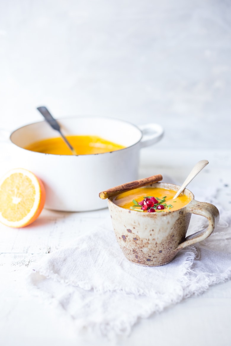 Simple, delicious Moroccan Carrot Soup with Ginger, Coconut milk, fresh orange juice and warming Moroccan Spices. Vegan and Gluten-free. Bright & cheery! #carrotsoup #moroccancarrotsoup #vegansoup 