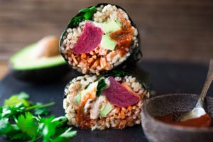 Delicious and healthy Sushi Burrito- filled with veggies, kimchi and your choice of ahi, tofu or smoked salmon. GF and Vegan adaptable | www.feastingathome.com