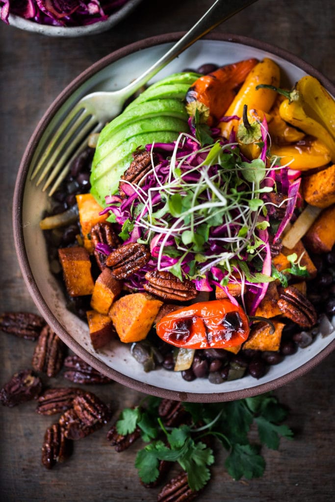 Mexican Oaxacan Bowl with roasted sweet potatoes, black beans, avocado, and cabbage slaw.