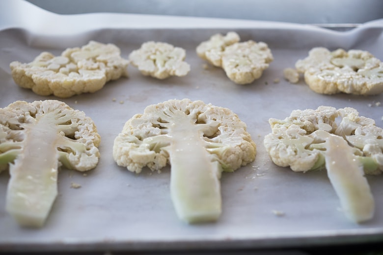  Zaatar Roasted Cauliflower Steaks with Green Tahini Sauce - a simple delicious vegan meal full of Middle Eastern flavor that can be made in 35 minutes. | www.feastingathome.com