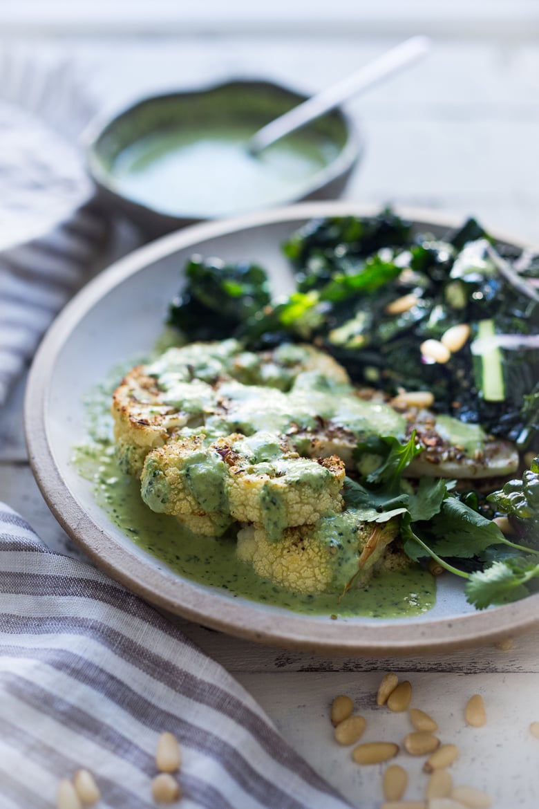  Zaatar Roasted Cauliflower Steaks with Green Tahini Sauce - a simple delicious vegan meal full of Middle Eastern flavor that can be made in 35 minutes. | www.feastingathome.com