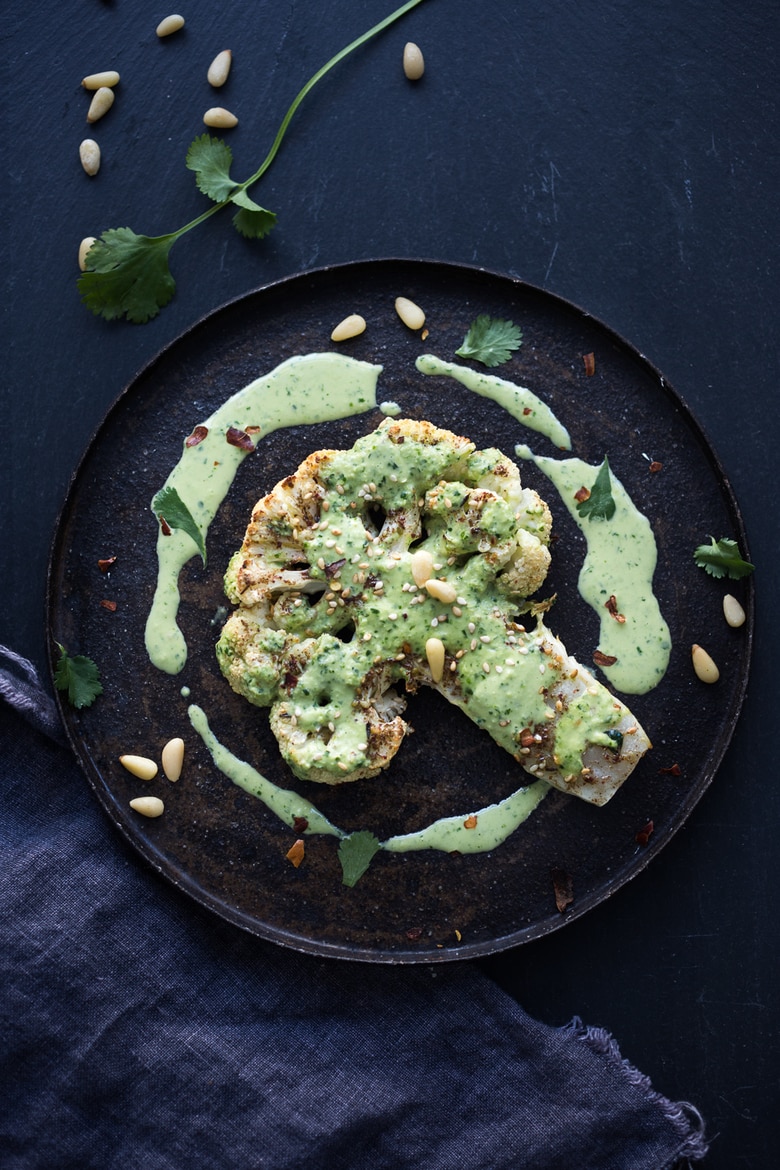  Zaatar Roasted Cauliflower Steaks with Green Tahini Sauce - a simple delicious vegan meal full of Middle Eastern flavor that can be made in 35 minutes. | www.feastingathome.com