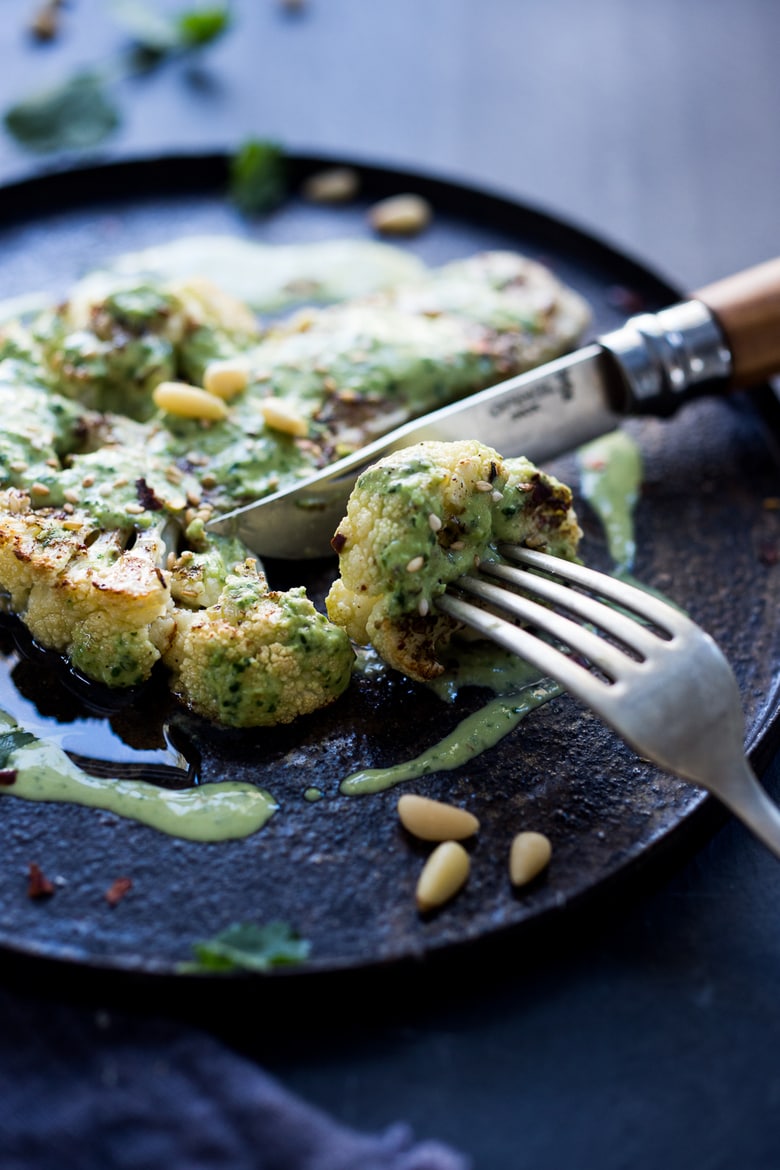  Zaatar Roasted Cauliflower Steaks with Green Tahini Sauce - a simple delicious vegan meal full of Middle Eastern flavor that can be made in 35 minutes. | www.feastingathome.com