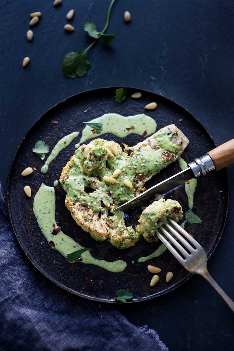  Zaatar Roasted Cauliflower Steaks with Green Tahini Sauce - a simple delicious vegan meal full of Middle Eastern flavor that can be made in 35 minutes. | www.feastingathome.com