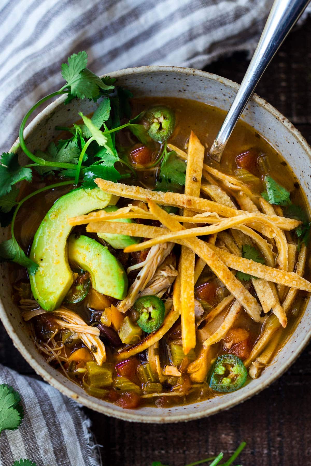 This Chicken Tortilla Soup is one of BEST recipes on the blog and hands-down one of our favorite dinners. Delicious and healthy, loaded with chicken and veggies, this soup will warm you to your bones! Make it in an Instant pot, on the stovetop, or in a slow cooker!