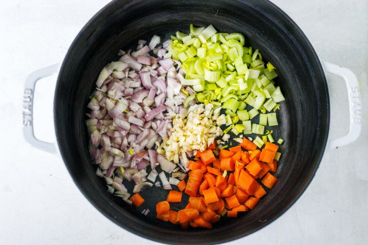 Sautéing the onion, garlic, carrots, and celery. 