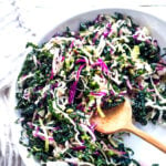 Everyday Kale Salad with simple Lemon Dressing can be made ahead, then used DAILY to top off tacos, wraps, buddha bowls, burgers, and even pizza during the week! Vegan and Gluten Free, this amazing kale slaw keeps for up to five days in the fridge. Meal Prep Savior! #kale #kalesalad #kaleslaw #mealprep #everydaysalad #kale #simplesalad | www.feastingathome.com
