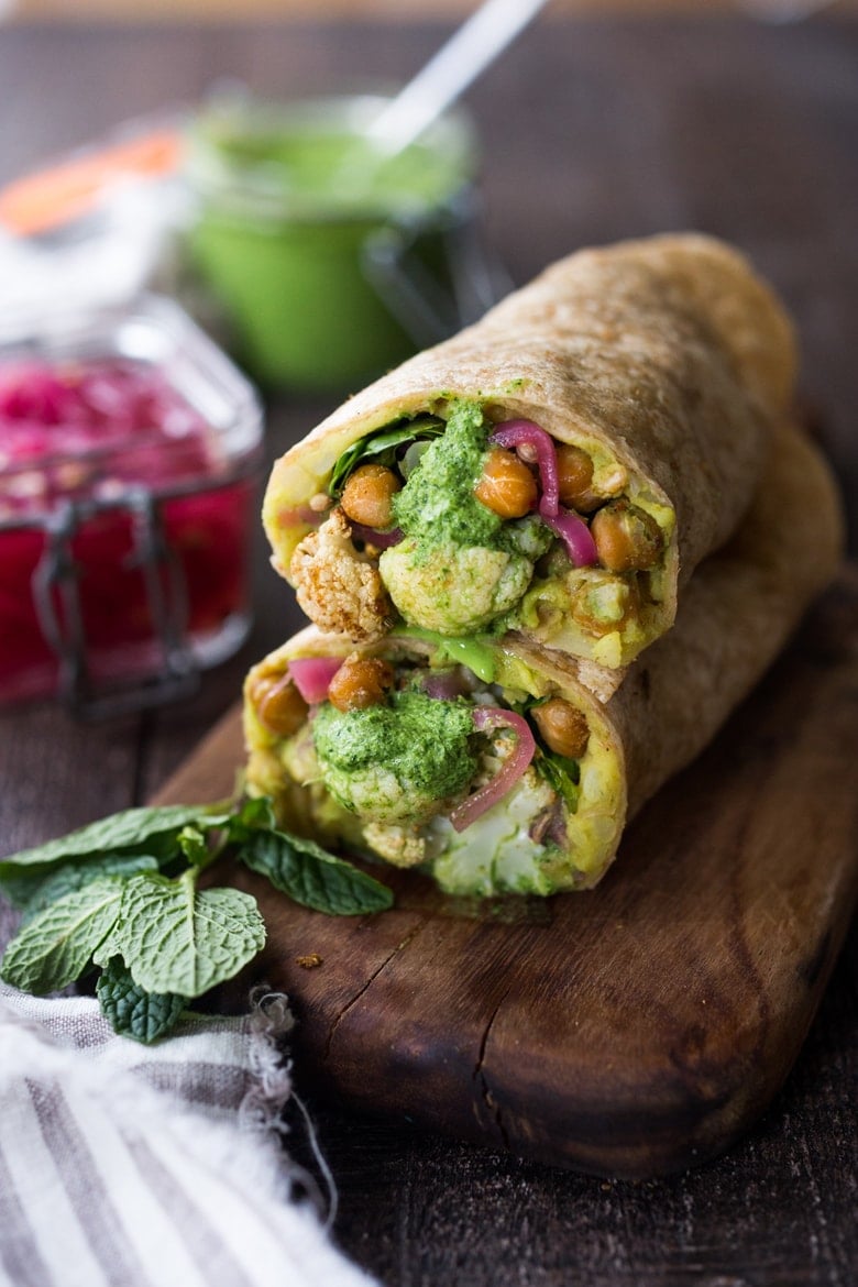 20 Must-try Chickpea Recipes from around the Globe! ||Frankies! India's flavorful street food, also called a Bombay Burrito. This vegan version is bursting with flavor-filled curry mashed potatoes, roasted Indian cauliflower and chickpeas, fresh spinach, mint chutney and pickled onions.| #frankie #frankies 