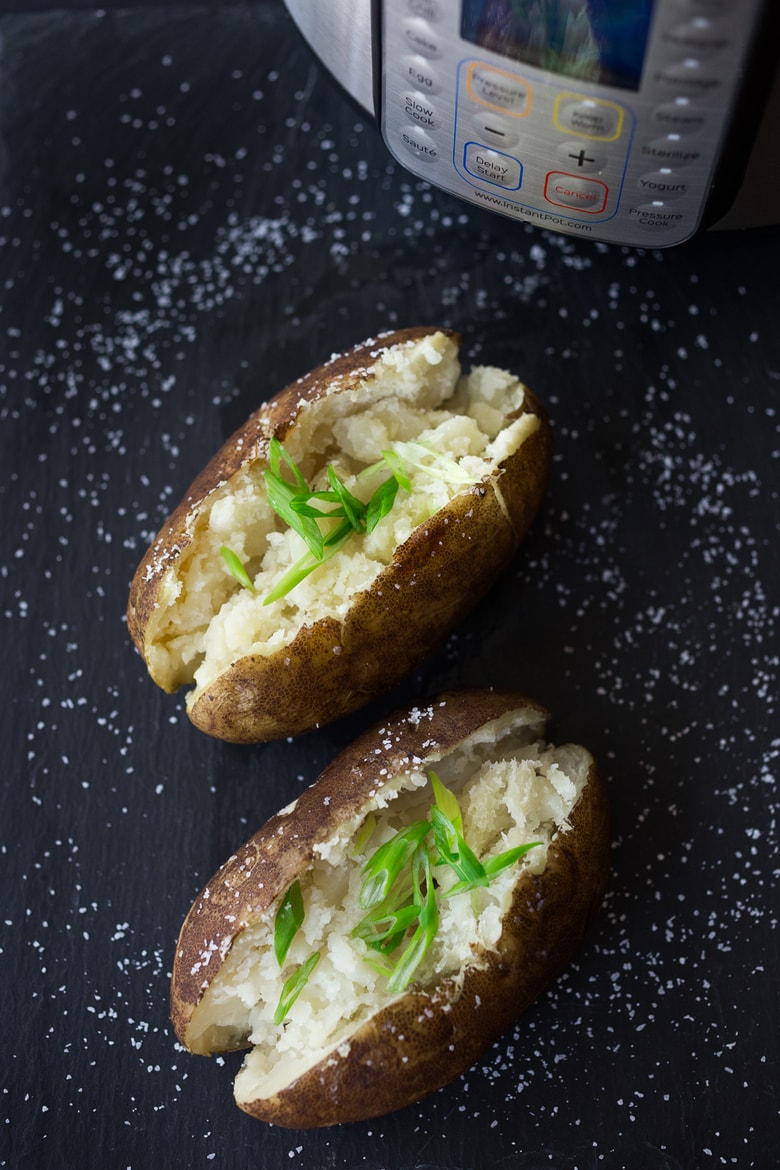 Instant Pot Baked Potatoes! Make fluffy baked potatoes in a third of the time! You'll never use your microwave again! A simple fast recipe for Baked Potatoes made in an Instant Pot or Pressure Cooker. | #feastingathome.com 