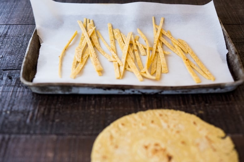 Homemade tortilla strips on a sheet pan. 