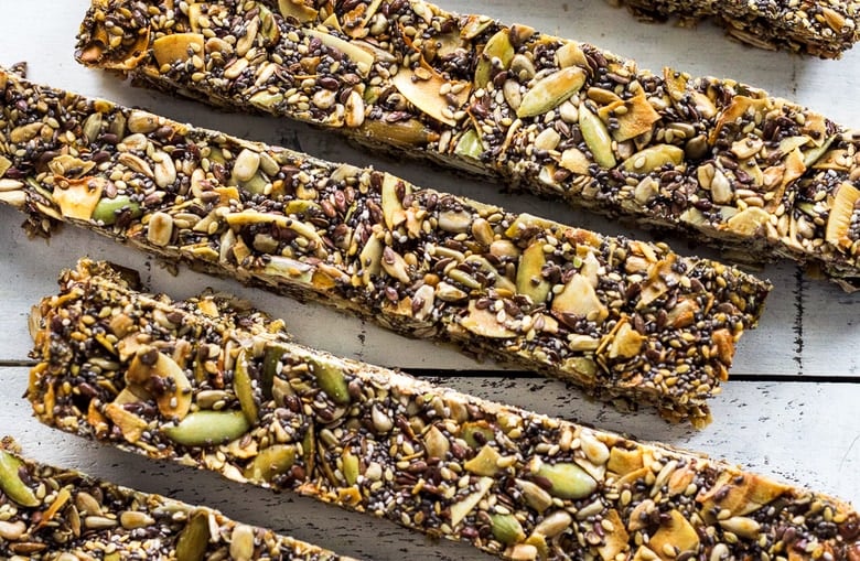 healthy homemade seed bars lined up next to each other.