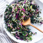 This simple Kale Slaw with Lemony Dressing can be made ahead, then used throughout the week to top off tacos, wraps, buddha bowls, burgers, and even pizza. An easy way to get in your dark leafy greens. Vegan and Gluten-Free, this amazing kale slaw keeps up to 4 days in the fridge.