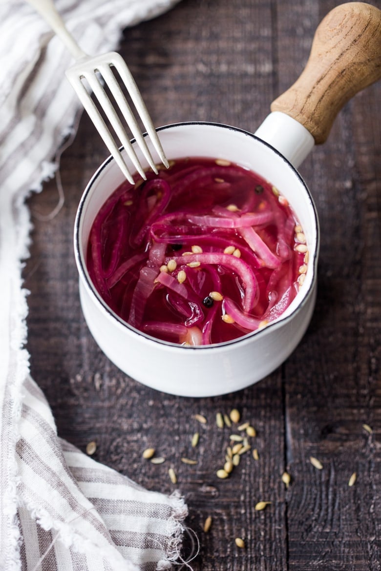 Quick Pickled Red Onions, that can be made in 10 minutes flat! Give your favorite foods like tacos, bowls, burritos, wraps, or grilled meats a huge burst of flavor in an instant. Store in the fridge for up to two months! This small batch recipe is fast and easy and will elevate many dishes you already make.| www.feastingathome.com